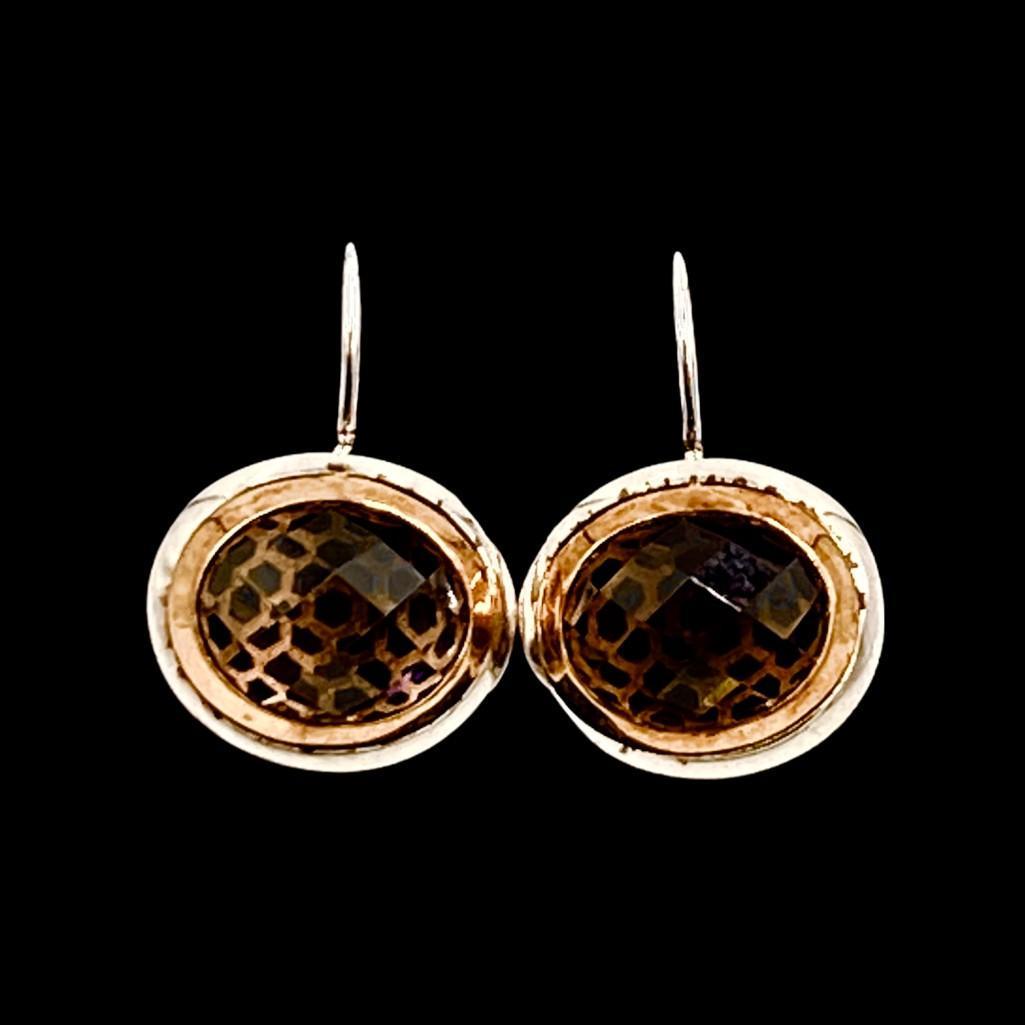 Smokey Topaz Ear Pendants: Sterling silver frames, suspended on hooks for pierced lobes, with fancy cut oval smokey topaz stones, apprx 1/2” x 3/4”W.
