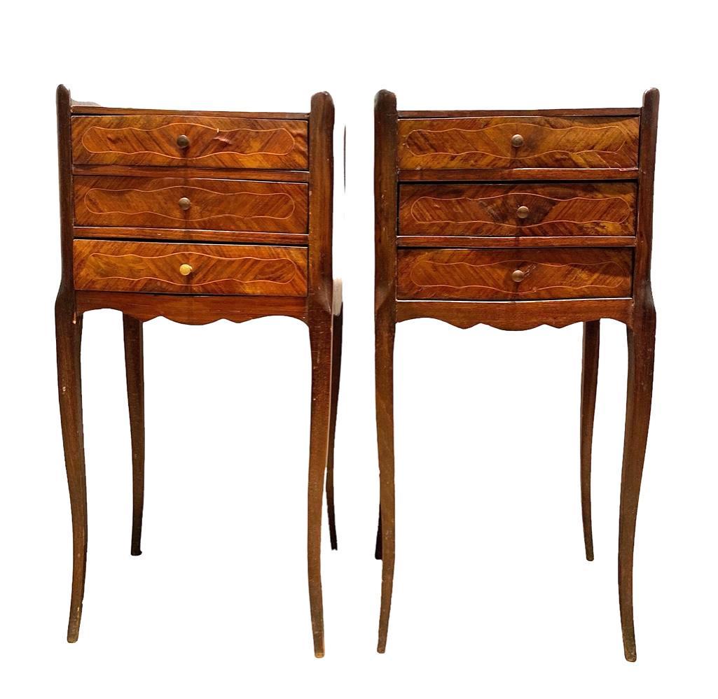 Pair of Louis XV Style Nightstands: Pair of Louis XV Style Nightstands, early 20thc. with shaped quarter veneered tops over three drawers, raised on cabriole legs. Dimensions: 27 in.h. x 13.25 x 11 in.d. Condition: chips, shrinkage and 