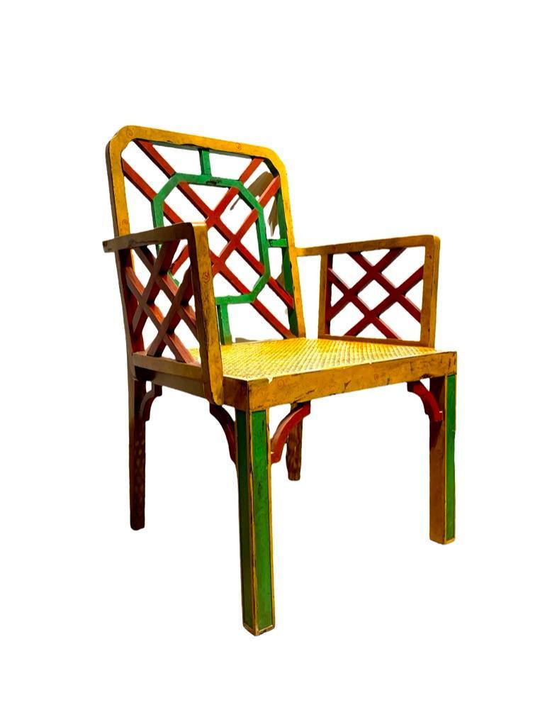 George III Style Painted Cockpen Armchair: George III Style Painted Cockpen Armchair, early 20thc, fretwork back and arms over caned seat on squared legs, painted in red, green abd yellow. Dimensions: 36 in.h. x 24.5 in.w. x 19 in.d. Condition