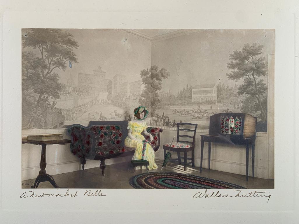 Wallace Nutting "A Newmarket Belle": Girl wearing bonnet sits on couch in formal room, Wallace Nutting Ref#3734, 13 x 17 inches, antique silver gelatin photograph with original hand coloring, framed, under glass. Not inspected out of fra