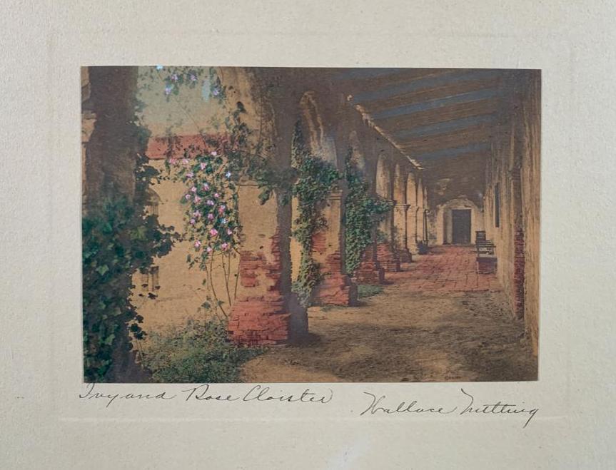 Wallace Nutting "Ivy and Rose Cloisters": View of ivy covered arches at pathway of Capistrano Mission, Wallace Nutting Ref#2197, 10 x 12 inches, antique silver gelatin photograph with original hand coloring, framed, under glass. Not inspected