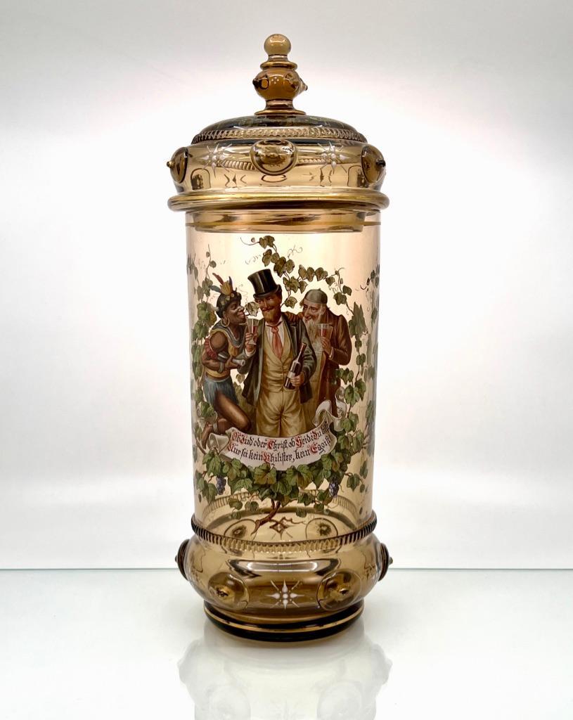 Theresienthal Enameled Glass Deckelhumpen, 19thc.: Theresienthal Kristallglas Fabrik Enameled Glass Deckelhumpen, c.1880, Bavarian, The clear light amber glass walls enameled with three figures enjoying wine, in a wreath of grapevines and leaves, with