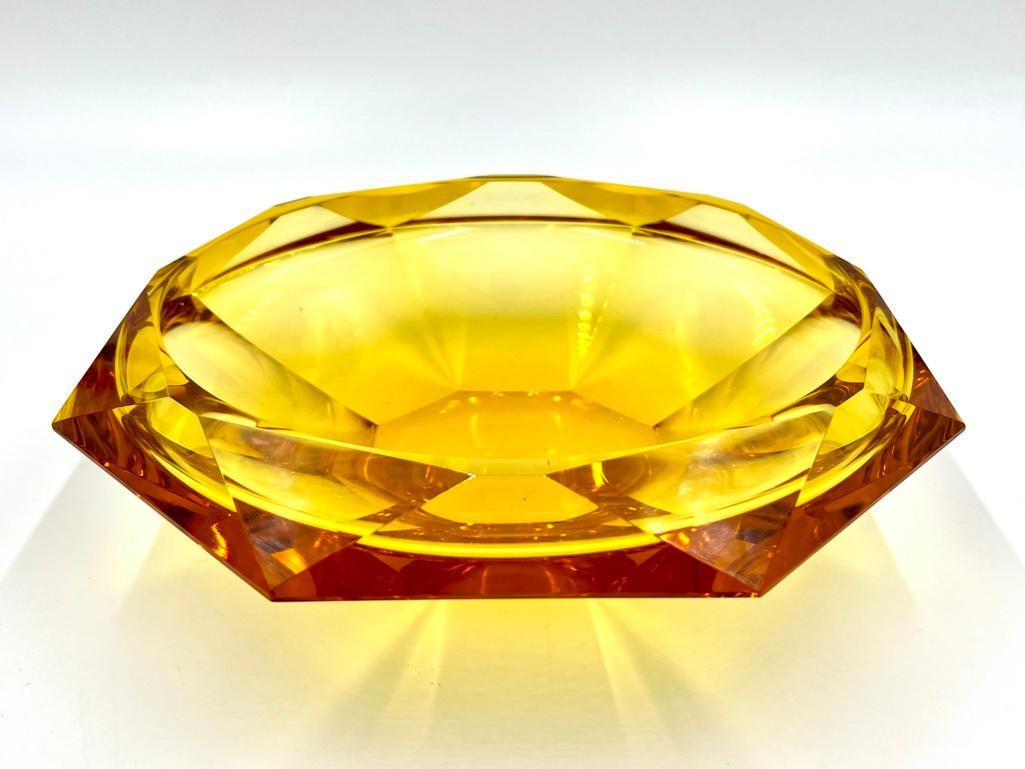 Moser Eldor Glass Bowl: Moser Eldor Glass Bowl, faceted bowl in clear golden yellow glass. Dimensions: 11.5 in. dia. 3.5 in.h. Condition: Two outer corners with small flakes. Some shelf wear to base.