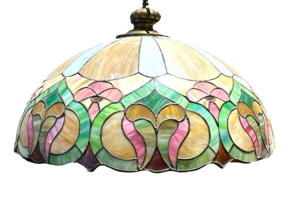 Leaded Glass Pendant Lampshade: Leaded Glass Pendant Lampshade, domed shade with paneled striated beige colored glass with stylized floral rim in pink, green and red, with scalloped rim. Dimensions: 24.5 in. dia, 17 in.h. including 
