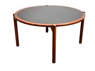 Hans Wegner Coffee Table: Hans Wegner Coffee Table with Reversible Top, c.1960, in teak, laminate and oak, the circular top on a conforming X-form base with four cylindrical legs joined by stretchers, the top lifting off to re
