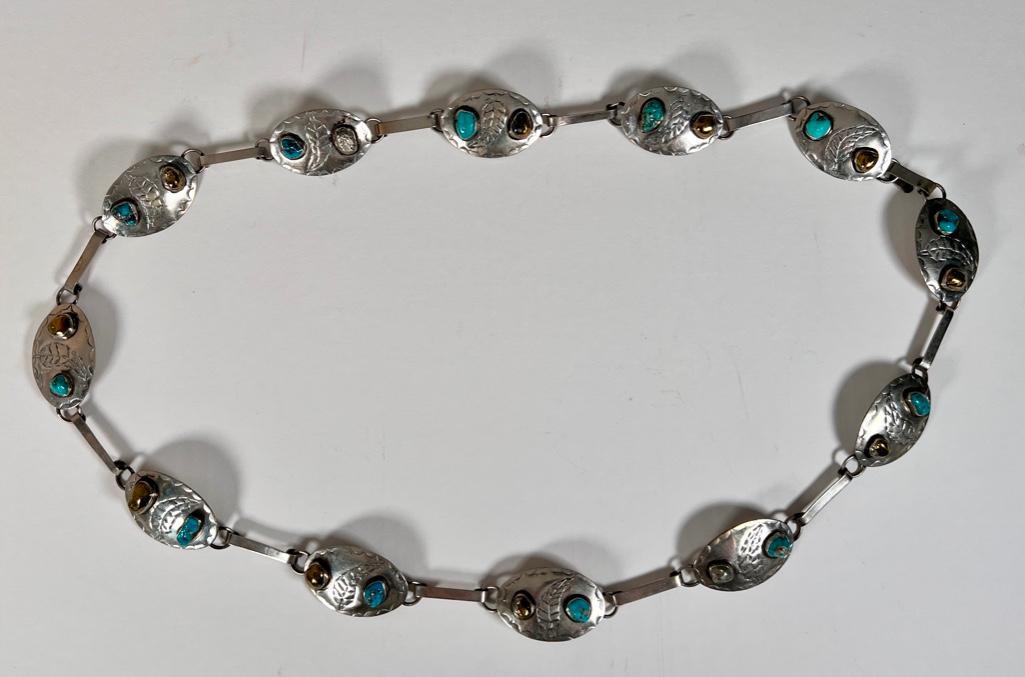 Sterling Silver Concho Belt with Turquoise and Marcasite: Twelve oval engraved medallions set with a natural turquoise and Marcasite bezel set stones, linked with flat bands to loops, apprx 21" in. L., apprx 6.3 oz, marked silver. Condition: very good.