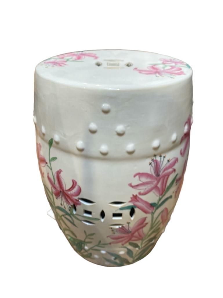 Chinese Ceramic Garden Seat: Chinese Ceramic Garden Seat, decorated with rubrum lilies in pink on a white ground. Dimensions: 18 in.h. x 12 in. dia. Condition: very good with no damage or restoration.