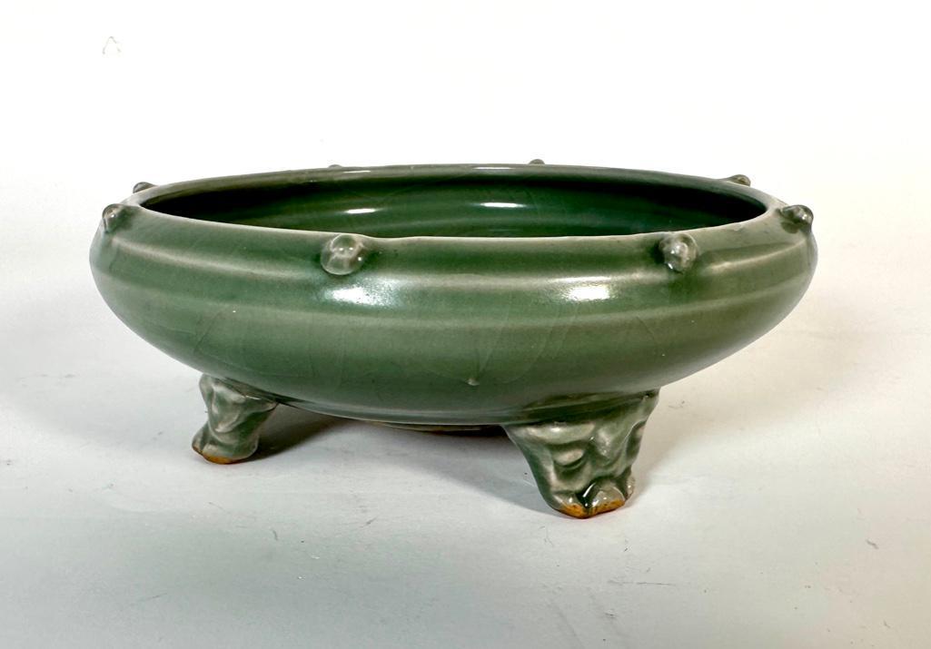 Chinese Longquan Style Celadon Glaze Tripod Censer: Chinese Longquan Style Celadon Glaze Tripod Censer, low open bowl form with applied prunts around the rim, the interior center left unglazed, raised on tripod taotie mask feet. Dimensions: 8 in.dia.