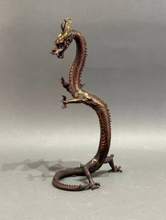 Japanese Bronze Figure of a Dragon, Modern: Japanese Bronze Figure of a Dragon, in fierce pose raised on hind legs, in bronze with brown and copper toned patination with gold toned highlights, unsigned. Dimensions: 18.5 in.h. Condition: Very g