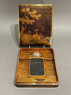 A Fine Japanese Lacquer Suzuri-bako, Autumn Night with Deer: A Fine Japanese Lacquer Suzuri-bako (Writing Box), c.1910, decorated with a pair of deer in a nighttime autumn landscape, with a maple tree and grasses by a stream, in gold with accents of silver set