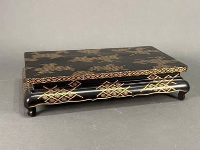 Japanese Lacquer Table: Japanese Lacquer Table, probably late 19th-early 20th century in date, Is decorated with floral and geometric patterns in gold and silver over a black lacquer ground. Dimensions: L. 12 1/2" W.