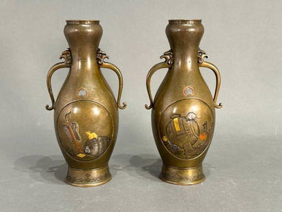 Pair of Japanese Bronze and Mixed Metal Vases, Meiji Period: Pair of Japanese Bronze and Mixed Metal Vases, Meiji Period, slender bottle shaped forms with applied handles, decorated in oval reserves with a rat climbing on a hammer of Daikoku (the god of wealth)