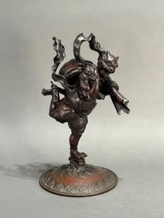 Japanese Bronze Figure of an Oni Stealing Futen's Wind Bag: Japanese Bronze Figure of an Oni Stealing Futen's Wind Bag, Meiji period, cast in two pieces, depicting the horned two clawed and two toed Oni delighted at his capture, on circular base cast with