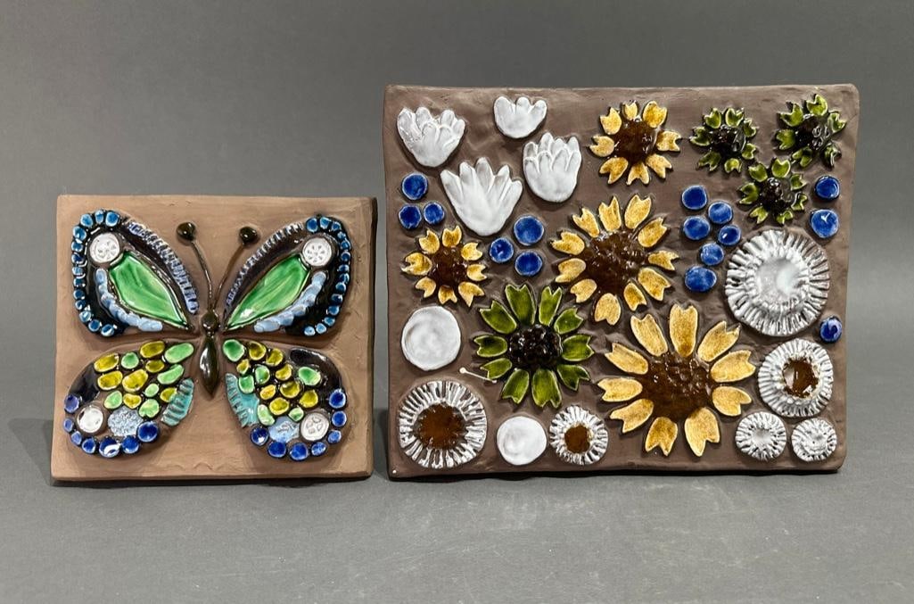 Two Jie Gantofta Sweden Glazed Ceramic Tiles,: Two Jie Gantofta Sweden Glazed Ceramic Tiles, each glazed in blue, green, white and yellow with floral designs and a butterfly. Stamped to verso. Larger signed with initials K.A. for Annika Kihlman. D