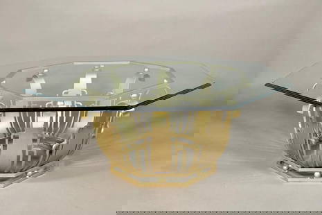 Art Deco Style Iron and Glass Coffee Table: Art Deco Style Iron and Glass Coffee Table, with beveled octagonal glass top on stylized gold painted iron base. Dimensions: 18 in.h. x 44 in. dia. Condition: Some wear and losses to gold painted fini