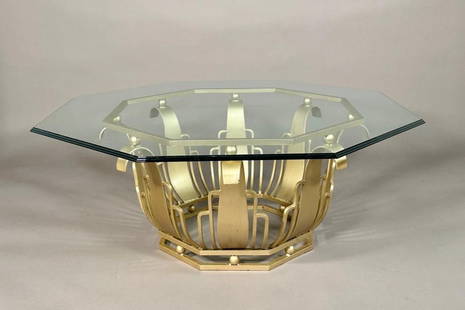 Art Deco Style Iron and Glass Coffee Table: Art Deco Style Iron and Glass Coffee Table, with beveled octagonal glass top on stylized gold painted iron base. Dimensions: 18 in.h. x 44 in. dia. Condition: Some wear and losses to gold painted fini