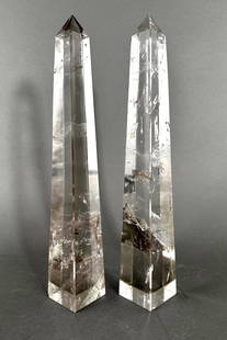 A Pair of Rock Crystal Quartz Obelisks: A Pair of Rock Crystal Quartz Obelisks, squared tapering forms. Dimensions: 14.75 in.h. Condition: One obelisk with chips to each corner of base. Second obelisk with some small chips/flakes to vertica