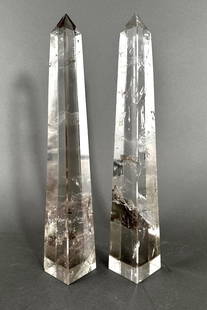 A Pair of Rock Crystal Quartz Obelisks: A Pair of Rock Crystal Quartz Obelisks, squared tapering forms. Dimensions: 14.75 in.h. Condition: One obelisk with chips to each corner of base. Second obelisk with some small chips/flakes to vertica