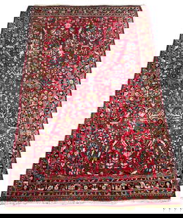 Red Sarouk Carpet 6'8" x 4'4": Wool on cotton foundation, overall red ground, directional flower fronds and sprays towards the center, negative spaces filled with discs and scattered blossoms. Small floral border finished with barb