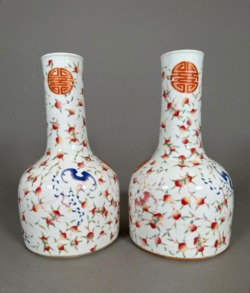 Pair of Chinese Famille Rose Vases: Pair of Chinese Famille Rose Vases, modern, are painted with motifs of peaches (symbol of immortality) and bats (symbol of happiness) with overglaze enamels in rose, green and blue. The character for 