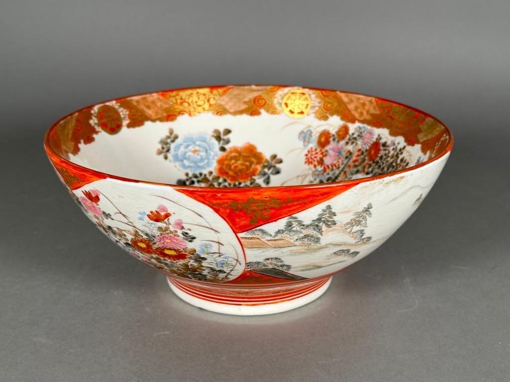 Japanese Kutani Porcelain Bowl: Japanese Kutani footed bowl, late 19th century, painted in the Kutani palette dominated by red and gold accents, the interior decorated with pheasants in a summer garden. A cottage and mountains are v