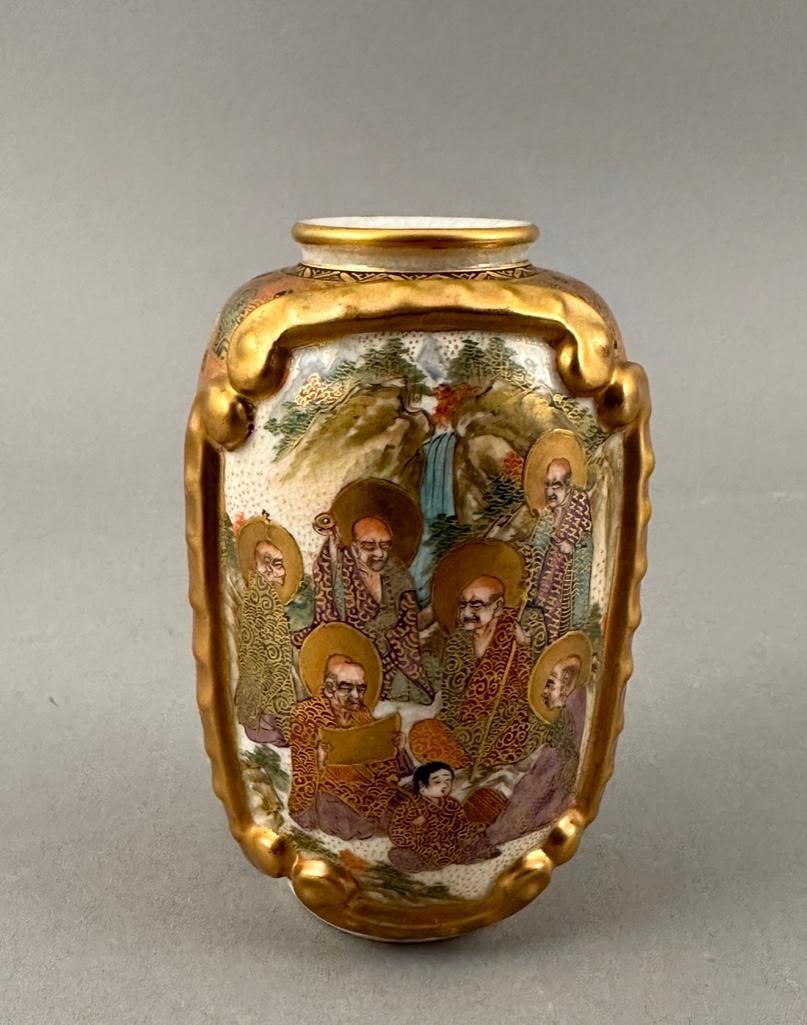 Japanese Satsuma Vase: Japanese Satsuma Vase, Meiji, of baluster form decorated to one side with Lohans in study and to the opposite side with a pheasant in a floral filled garden. Signed to base. Dimensions: 5 in.h. Condit