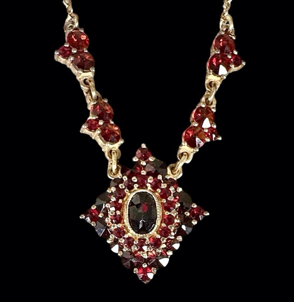 Antique Bohemian Vermeil Garnet Necklace: Shaped pendant with central faceted oval garnet, accented with European cut garnets, apprx 9 grams, 9.5"L. Condition: light wear to vermeil.