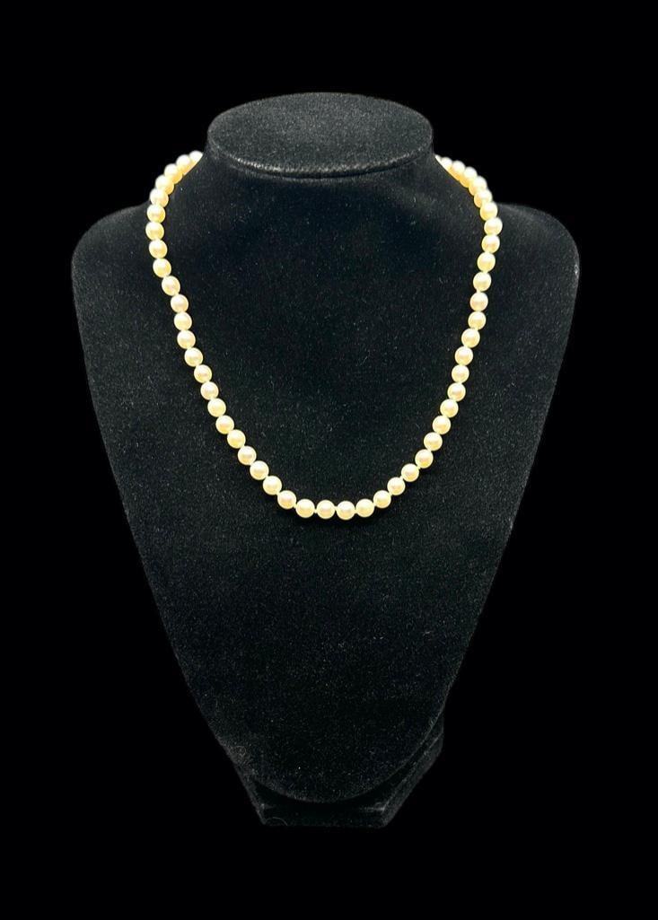Pearl Choker With White Gold Clasp: Necklace strung with apprx .5mm cream color pearls, apprx 16"L. Marked 14 K white gold textured gold clasp. Condition: Very nice.