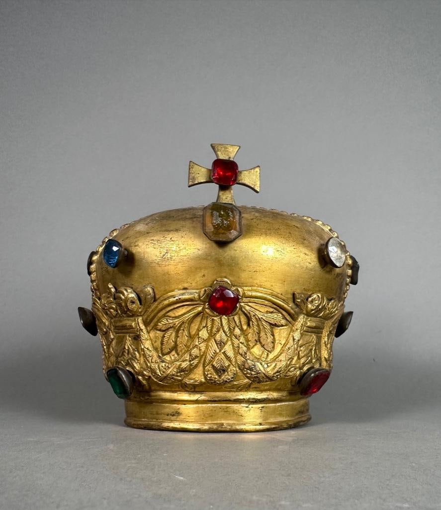 Antique Gilt Santo Crown: Gilt brass crown, applied with mounted paste stones, Open cap with chased swags, leaves and flowers around base, supporting a cross. Apprx 7"T x 7"D. Condition: uneven patina,, some fading of