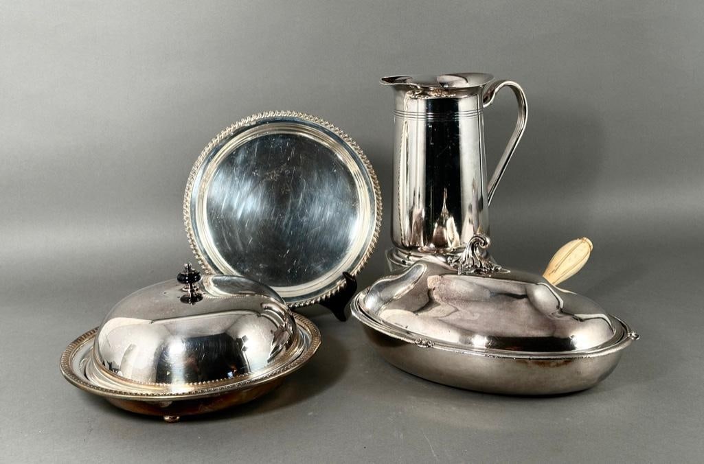 Silver Plate Lot: Silver Plate Lot, including a kidney shaped covered vegetable dish with fitted insert and bone handle, a water pitcher and a covered serving dish and circular tray. Dimensions: Kidney shaped dish: 12 