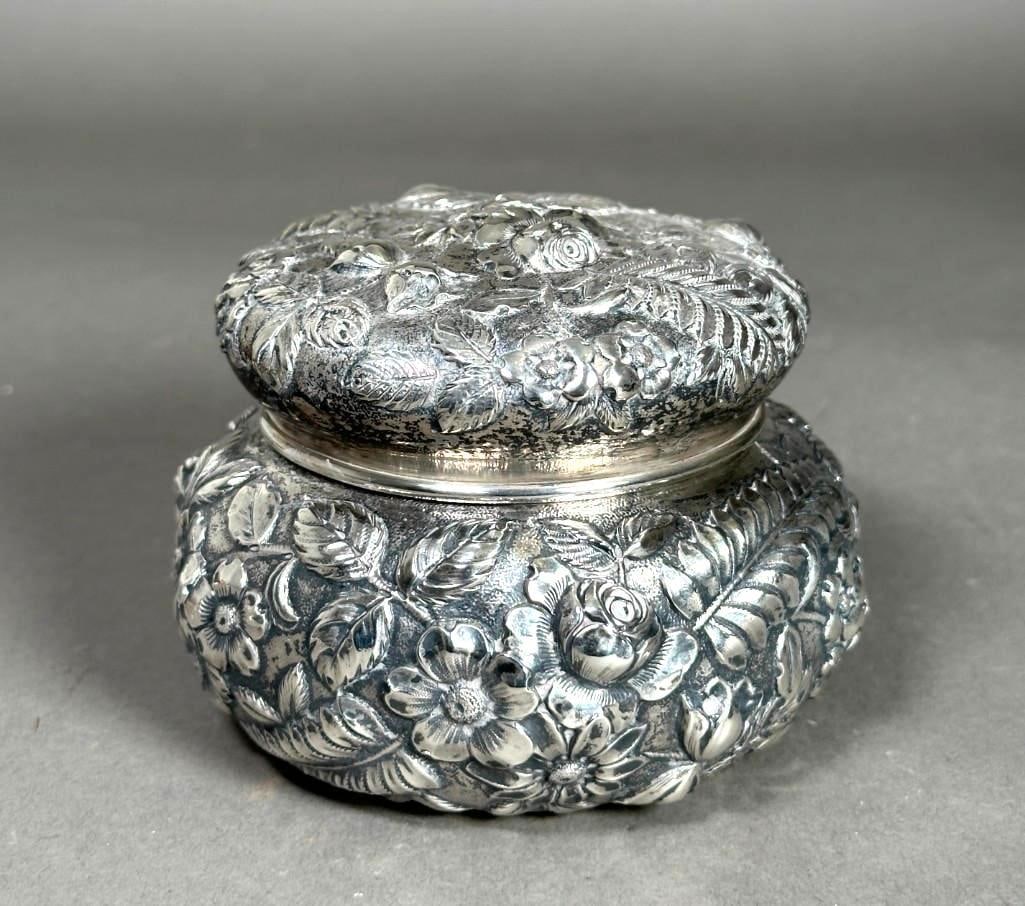 S. Kirk and Son Repousse Powder Jar, c.1846: S. Kirk and Son Repousse Powder Jar, Baltimore, c.1846, decorated in repousse with flowers and ferns, stamped to base. Dimensions: 3.25 in.h. x 5 in dia. Condition: Very good with no damages. Scuffs t
