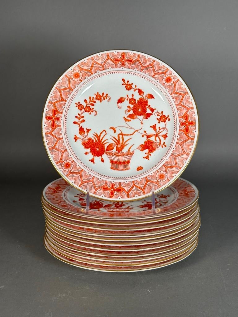 Twelve Royal Crown Derby Luncheon Plates, Chandos Pattern: Twelve Royal Crown Derby Luncheon Plates, Chandos Pattern, decorated in Japanese style in ron red glaze with a basket issuing flowers, with gilded rims. Dimensions: 9.25 in. dia. Condition: Light wear
