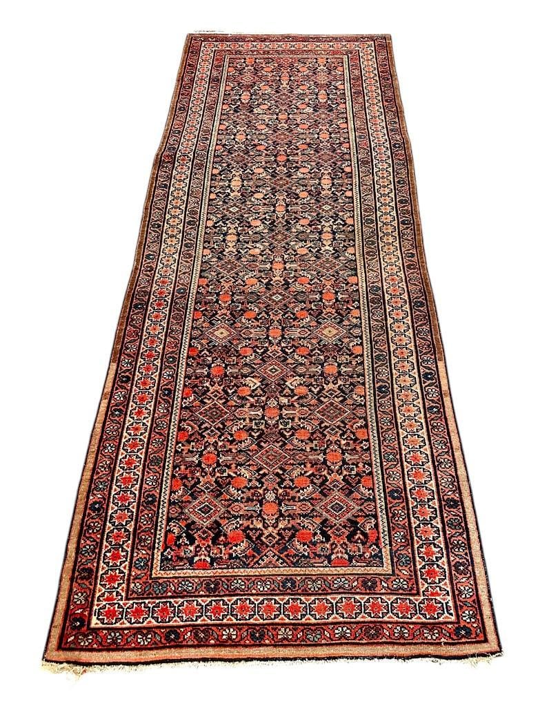 Persian Wool Fereghan, 9'5 x 3'6: Persian Wool Fereghan, c.1920's-30's. The field with allover geometric designs in salmon, red, tan and brown on a navy field, with tight geometric borders. Provenance: Norton Gardner Antiques,
