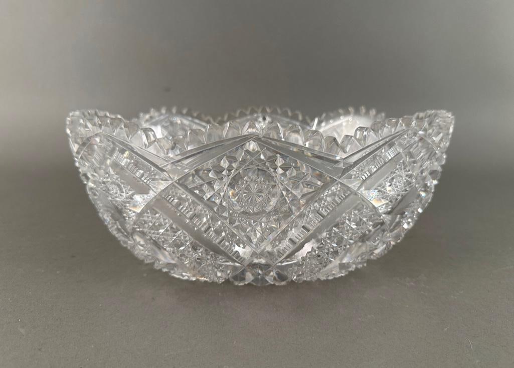 American Brilliant Period Cut Glass Bowl: American Brilliant Period Cut Glass Bowl, oval bowl form with tall sides, cut with hobstars, fans and diamond patterns, with sawtooth edge. Dimensions: 10 x 7.25 in. Condition: Some scattered chips to