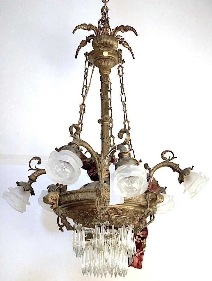 Antique French Bronze Six-Light Chandelier: Antique French Bronze Six-Light Chandelier, with floral frond surmount and central standard supporting six scrolled arms with frosted floriform shades, the base cast with decorative motifs and two tie