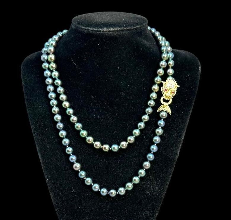 Tahitian Pearl Necklace with Gold Dragon Head Clasp: Blueish-green 7mm pearls, hand knotted, apprx 17"L. The clasp is marked 14K yellow gold, as a Chinese style dragon with diamonds, green tourmaline and pink topaz accents. Condition: excellent.