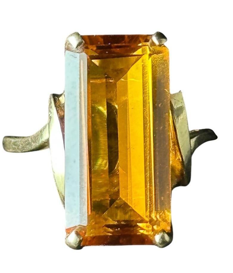 A 6 Carat Orange Sapphire Vintage Ring: Orange color, tests as sapphire, elongated emerald cut, measuring apprx 17mm x 10mm x 5mm, apprx 6 carats prong set into 10K yellow gold setting. Apprx 5 grams, ring size 7.5. Does not have papers or 