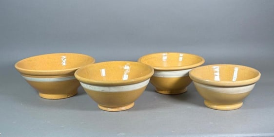 Four Matching Graduated Yellow Ware Bowls