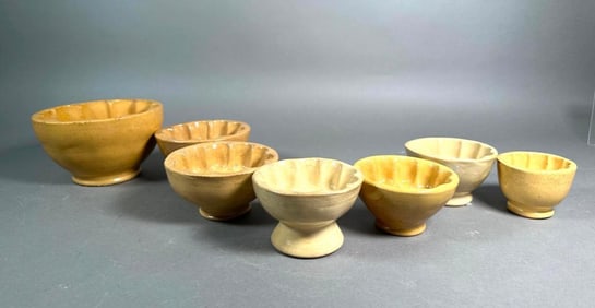Seven Small Round Yellow Ware Food Molds