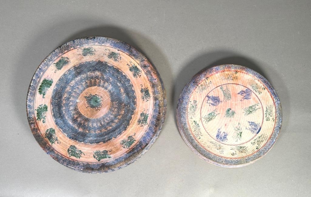 Two American Spongeware Trivets: Sponge glazed pottery trivets, one is 1-1/2"T x 14-3/4"W with teal and cobolt blue sponged decorations, glazed underside with old repair on foot-rim as pictured. The second smaller pottery tri