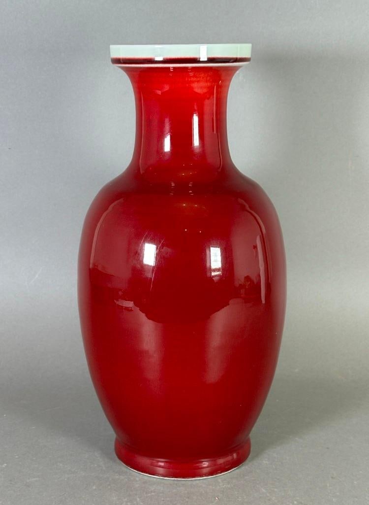Chinese Oxblood Glaze Vase: Chinese Oxblood Glaze Vase, modern, of baluster form covered in deep red glaze shading to white at the top, with underglaze blue sealÂ mark to the base. Dimensions: 14 in.h. Condition: very good wit
