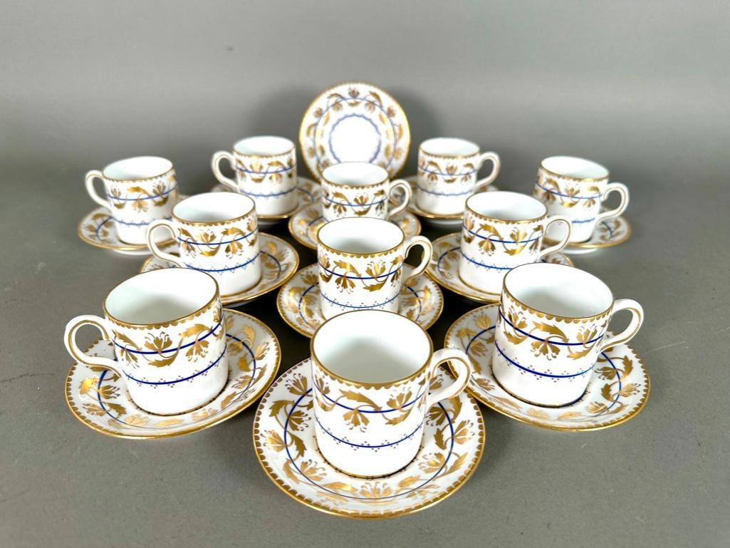 New Chelsea Staffordshire Demitasse Cups and Saucers: New Chelsea Staffordshire Demitasse Cups and Saucers, comprising 11 demitasse cups and 12 saucers decorated in cobalt blue and gilding. Dimensions: 4.25 in. dia. of saucer Condition: Very good conditi