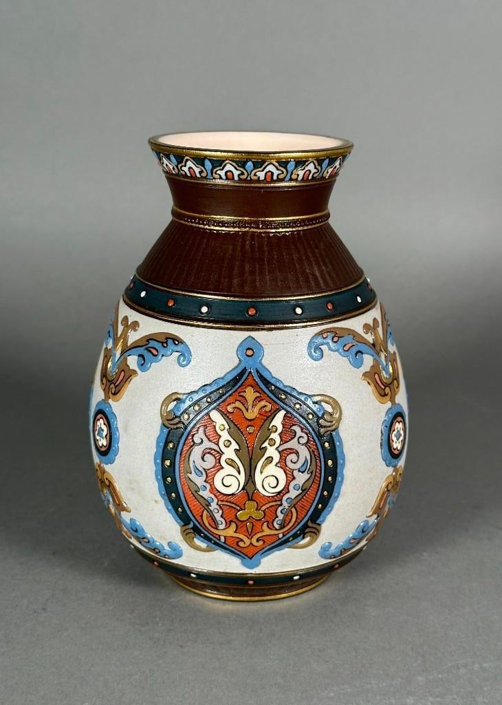 Mettlach Vase: Mettlach Vase, of globular form with everted mouth, decorated with applied cartouche and scroll motifs, stamped Mettlach with shape number 1829. Dimensions: 7.25 in.h. Condition: Very good.