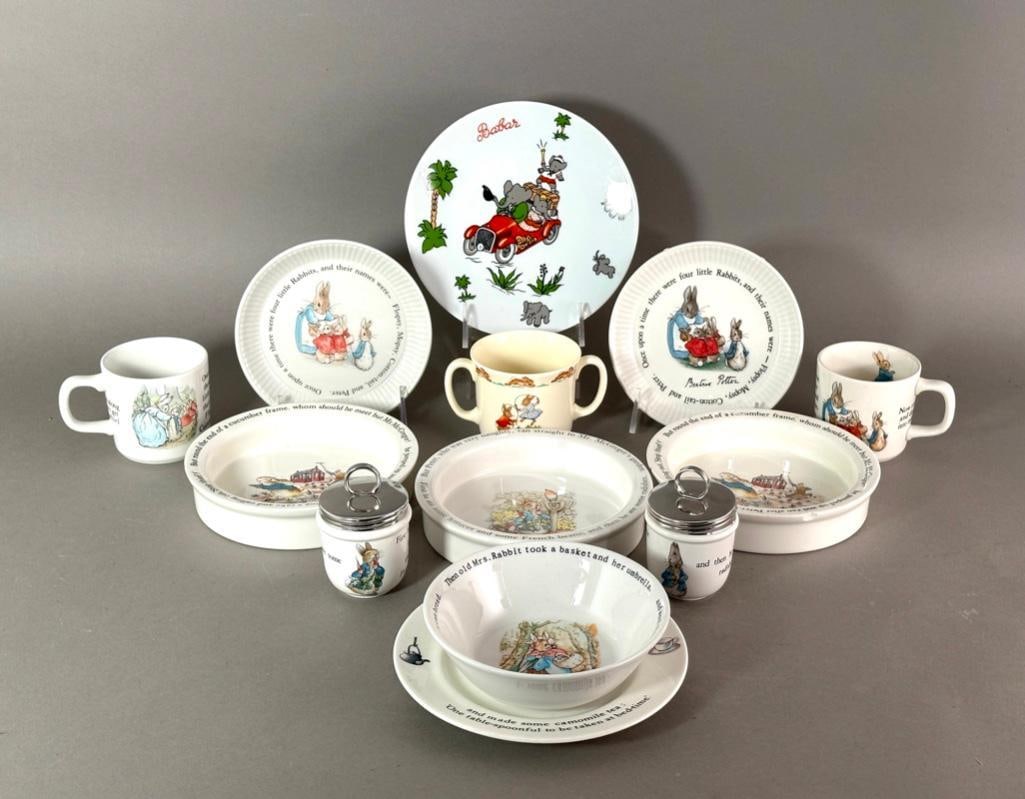 Wedgwood Peter Rabbit Juvenile China Group: Wedgwood Peter Rabbit Juvenile China Group, comprising 3 small plates, 3 porringers, 2 covered egg coddlers and 2 mugs, together with a Royal Doulton Bunnykins two handled mug and a Babar plate. Dimen