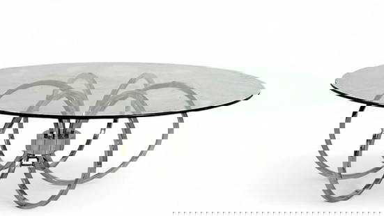 Modern Chrome and Glass Coffee Table: Modern Chrome and Glass Coffee Table, circular glass top on a six ringed chrome base. Dimensions: 16 in.h. x 44 in. dia. Condition: Very good.