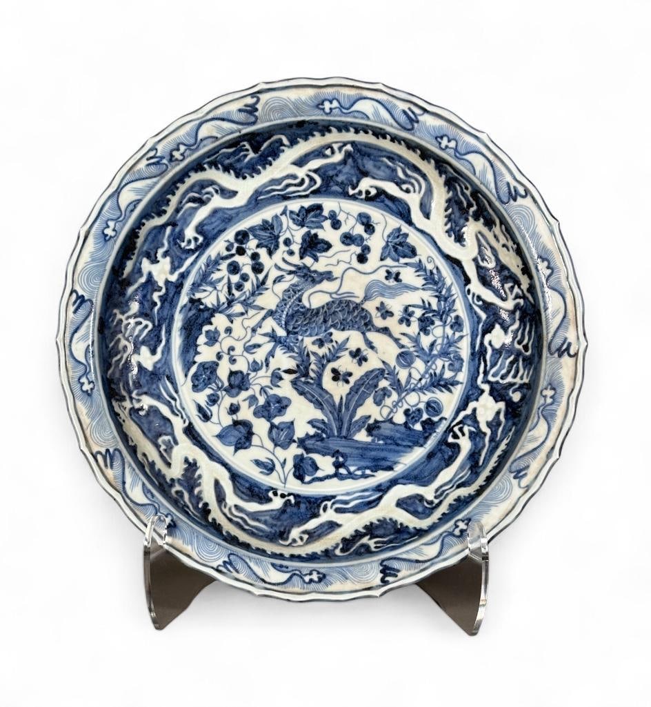 Chinese Blue and White Yuan Style Porcelain Basin, Modern: Chinese Blue and White Yuan Style Porcelain Basin, Modern. Deep scalloped rim form decorated in an allover pattern with a Qilin bounding through a forest with trees and berries, with a reverse glaze d