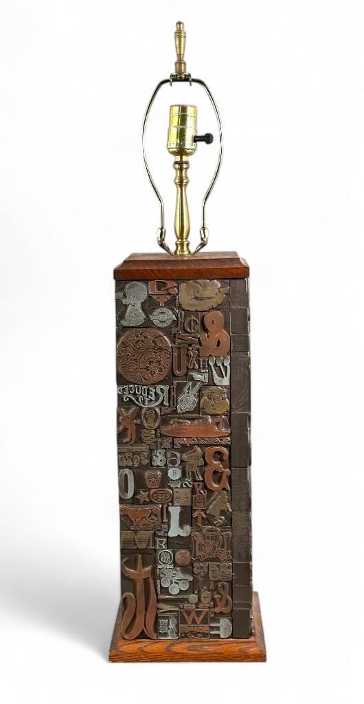 Printer's Blocks Table Lamp, 1960's: Printer's Blocks Table Lamp, 1960's, squared form set with various printers blocks of logos, letters and numbers, possibly by Brian Bradley. Dimensions: 18 in.h. not including hardware. Condition: Chi