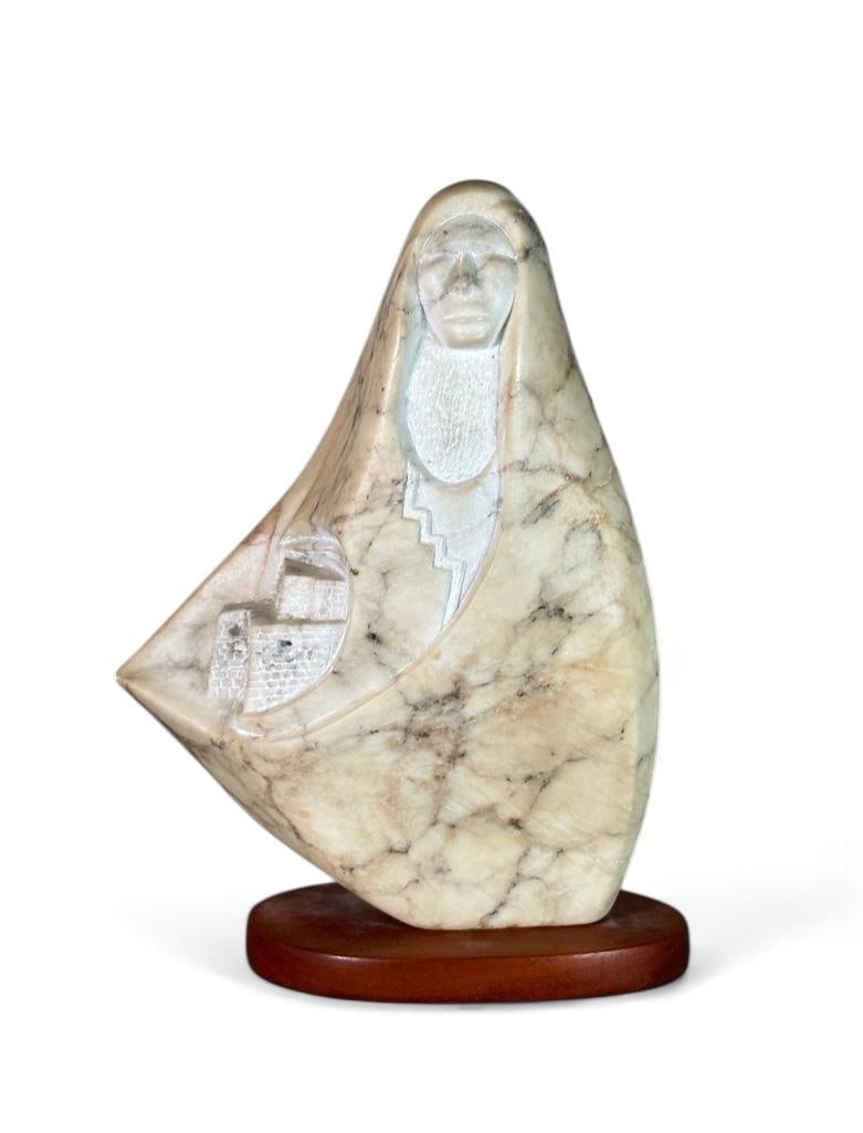 Paul Chopito Zuni Carved Stone Sculpture: "Sacred Gaurdian" Carved gray color stone, depicting a Zuni Indian woman in flowing garment, signed on recto near base, attached to wood base, titled and signed under base. Dimensions: Approx. H. 12-1