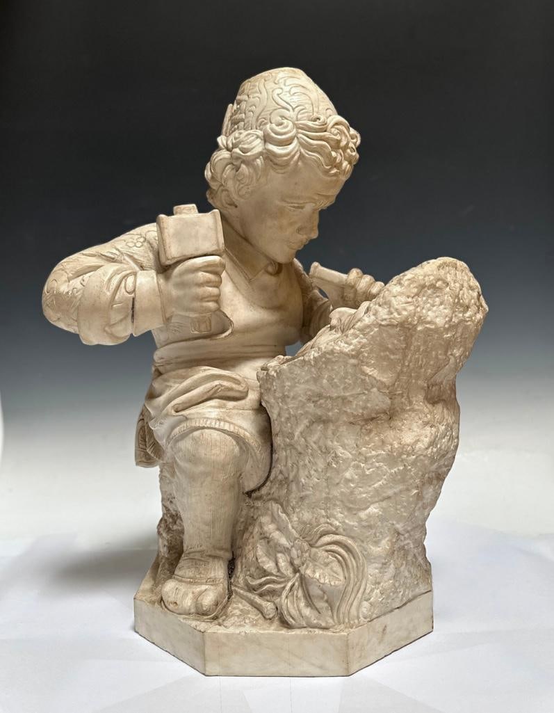 Italian Carved Marble Sculpture, The Boy Michelangelo Carving the Head of a Faun: Italian Carved Marble Sculpture, The Boy Michelangelo Carving the "Head of a Faun." After Emilio Zocchi (Italian 1835-1913) The carving of the mask, c.1489, (now lost) was purportedly Michelan