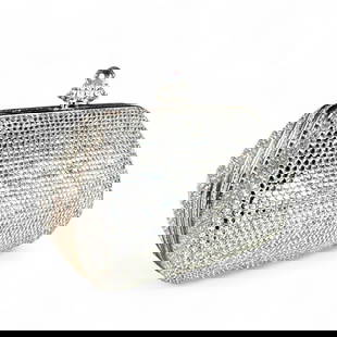 Judith Leiber Silver Swarovski Crystal Minaudiere Bag: Silver crystals, gold frame, faceted crystal clasp. Removable silver chain strap, flat bottom, rounded side and tapers to the top. Dimensions: Measures approx. 3.5T x 4.5W x 2.5D. Condition: Excellent